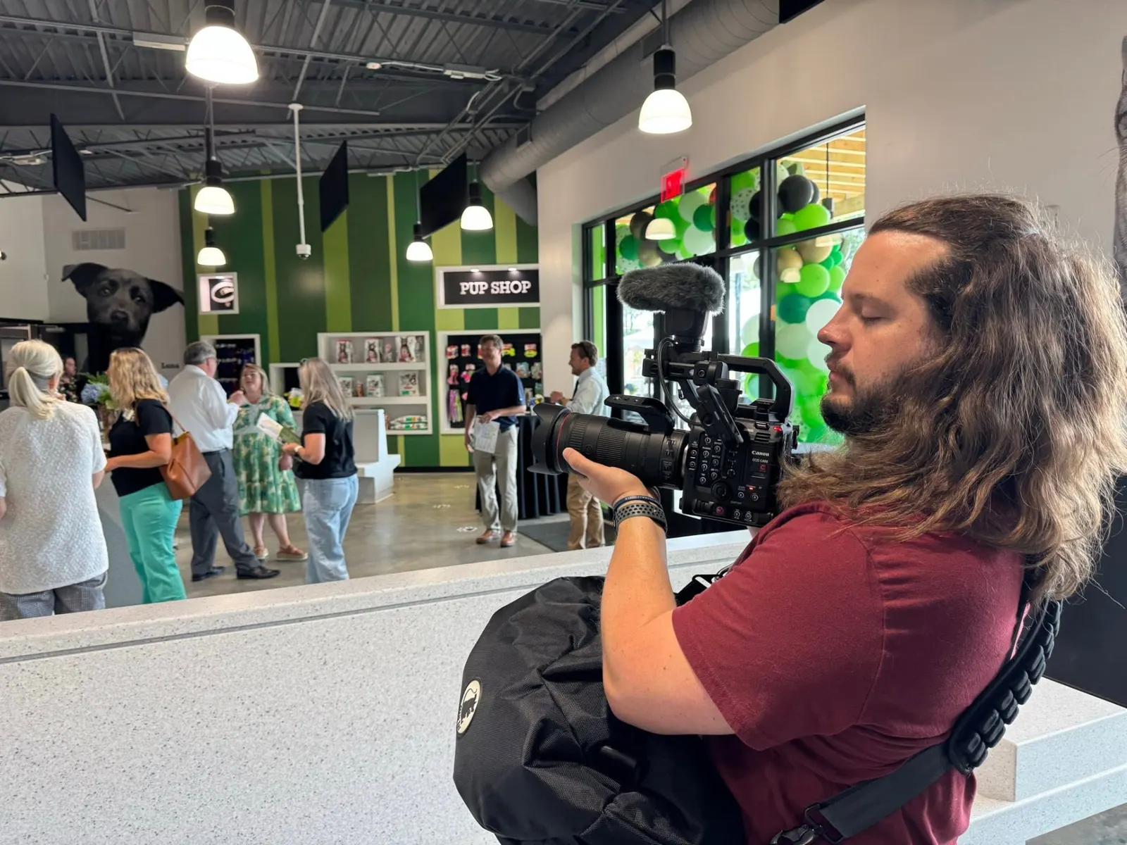 Camera operator filming a grand opening event