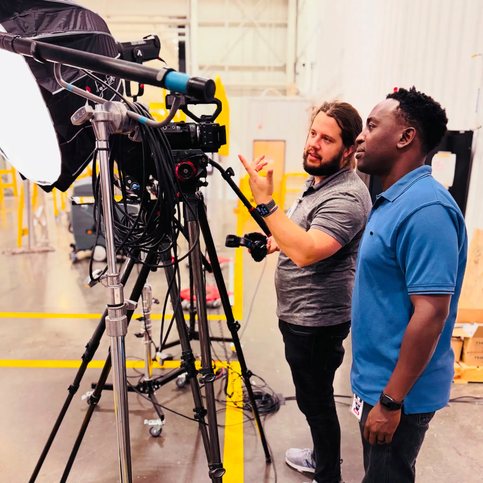 Crew reviewing a shot on a manufacturing floor